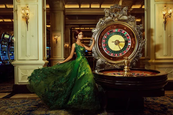 A close-up shot of golden coins falling around a spinning roulette wheel, representing immersive casino action at JILI696.