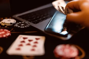 A woman smiling by bright slot machines showing lucky symbols, showcasing the exciting slot offerings at JILI696.